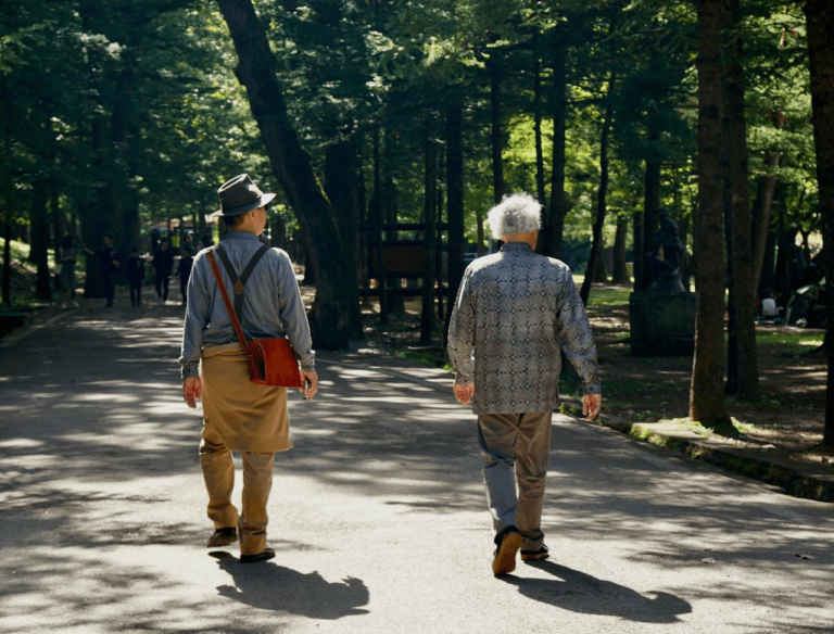 two elderly men walking