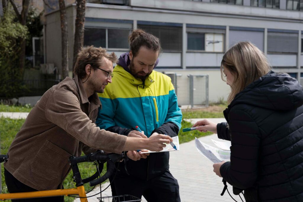 Three people on foot and by bycicle that are mapping their surroundings with the Sketch Map Tool