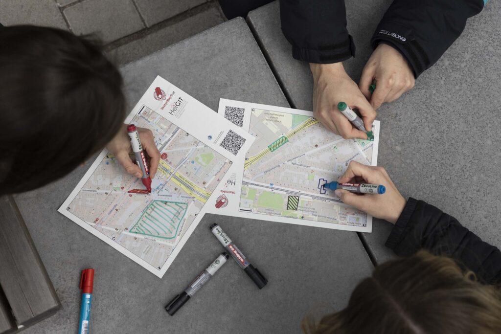 Three people are working on sketch maps.