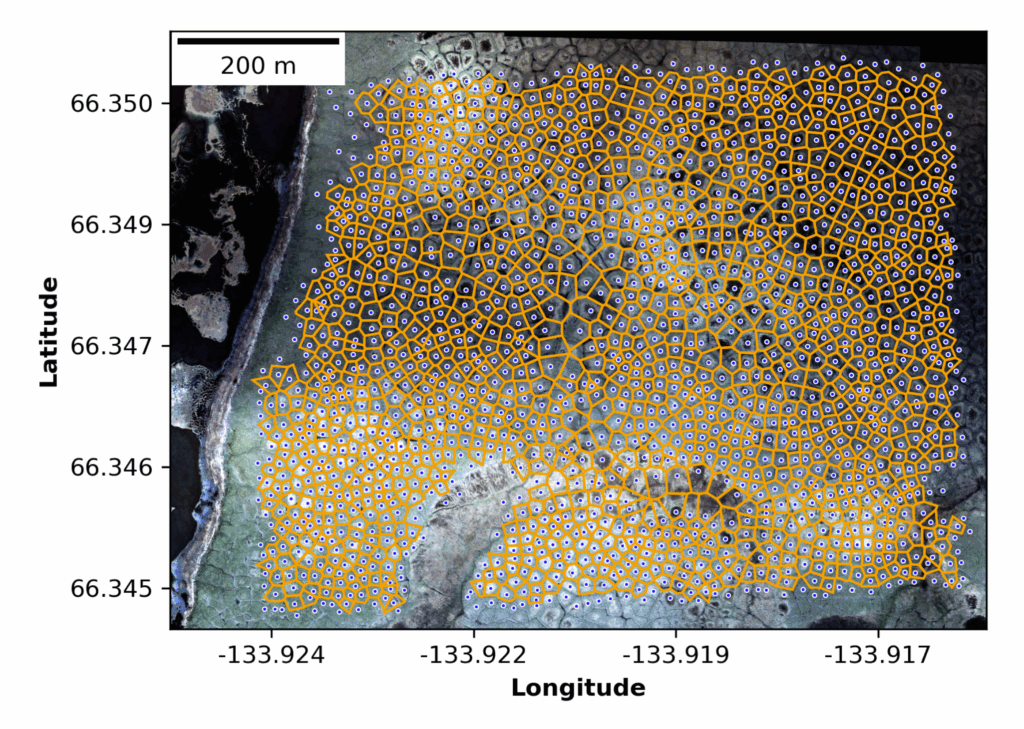 Aerial view of terrain with a grid of irregular orange polygons overlaying the landscape, showing latitude and longitude coordinates and a 200 m scale bar.