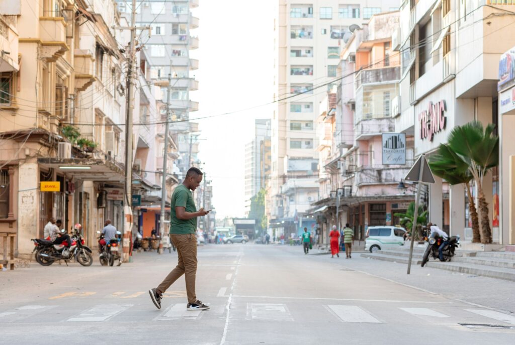Picture of a man walking across a street.
