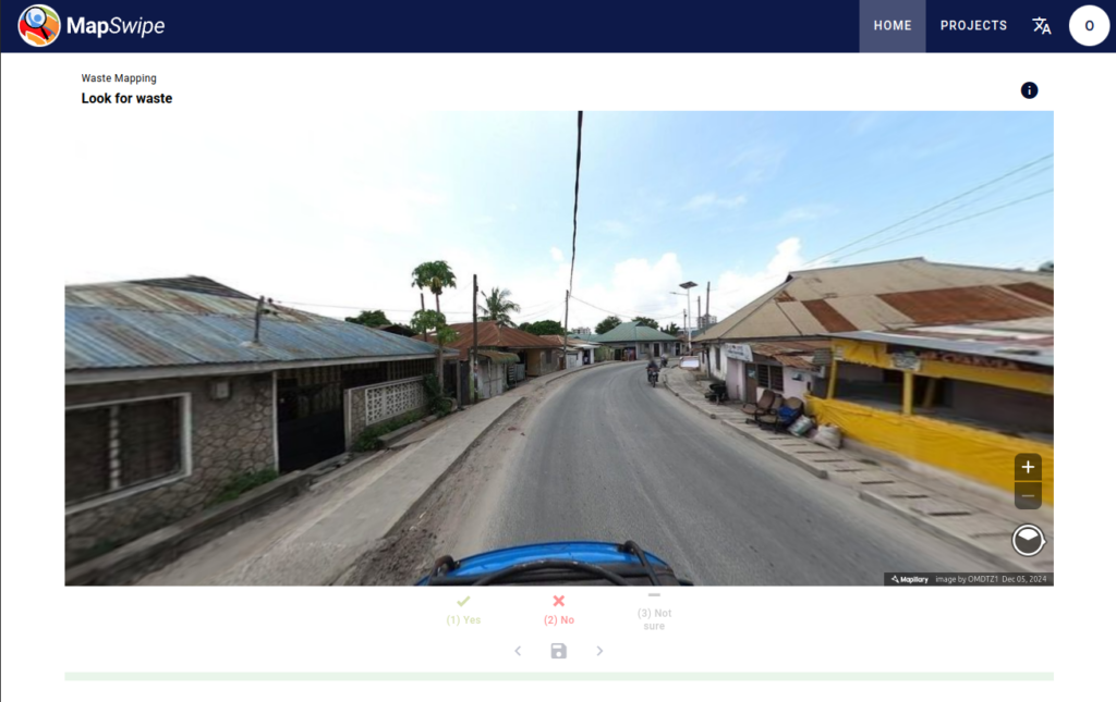 Street view of a rural area with houses on both sides and a clear sky