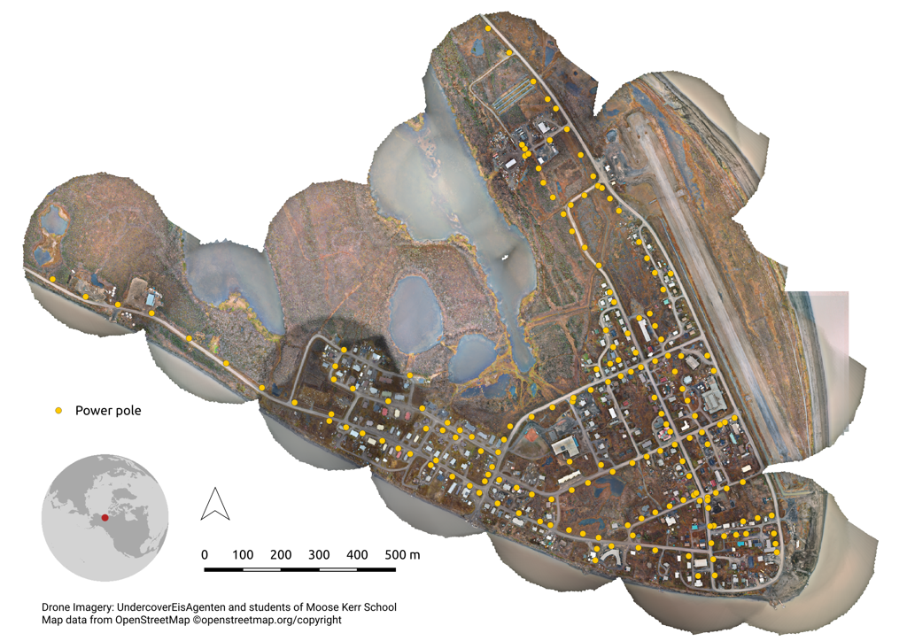 Aerial map showing a town with roads, buildings, water bodies, and marked power poles indicated by yellow dots