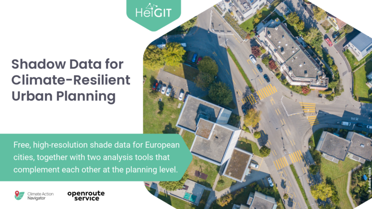 Aerial view of an urban area with buildings, roads, parked cars, and trees